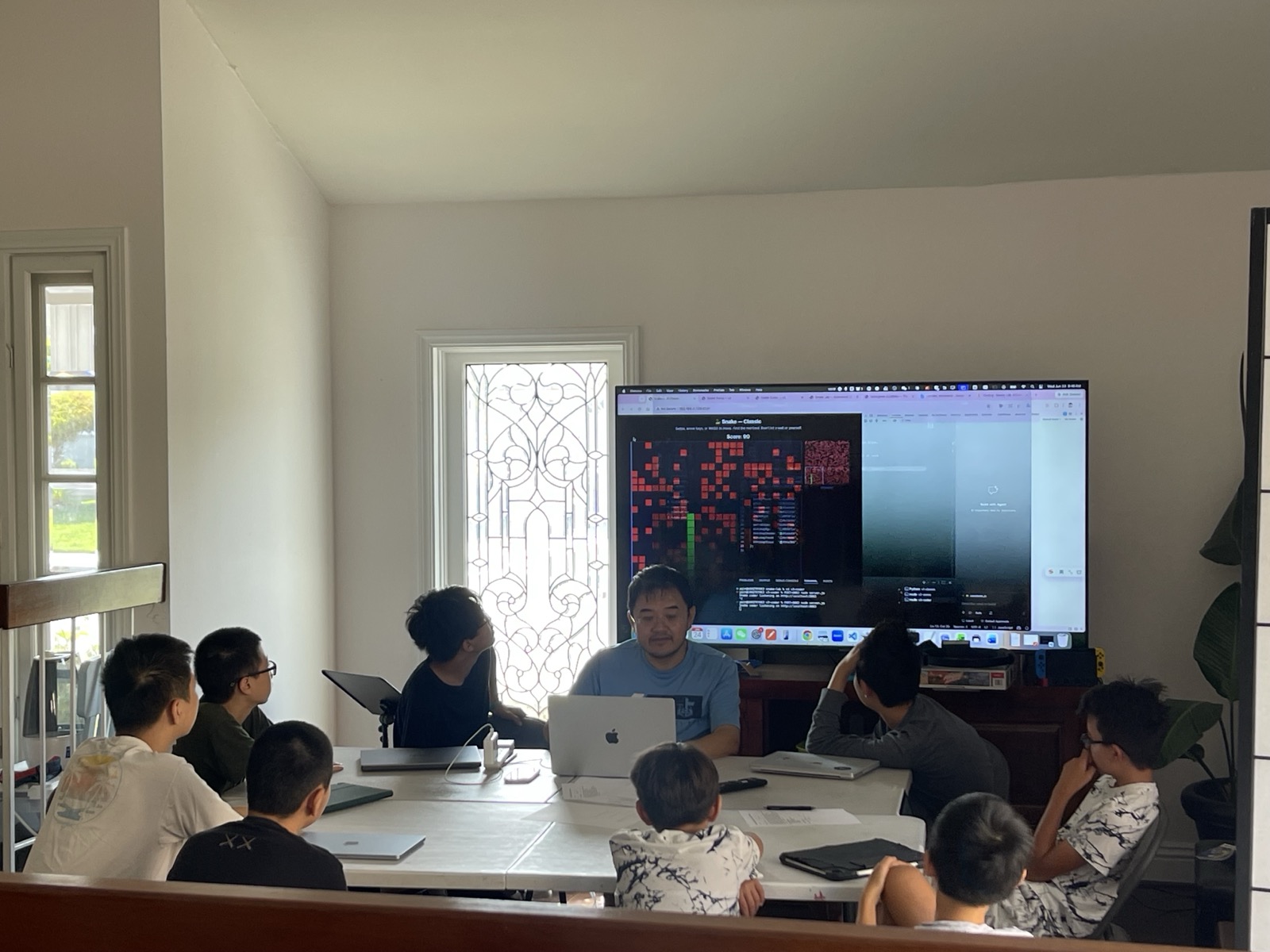 Campers watching a Snake game run on the big screen