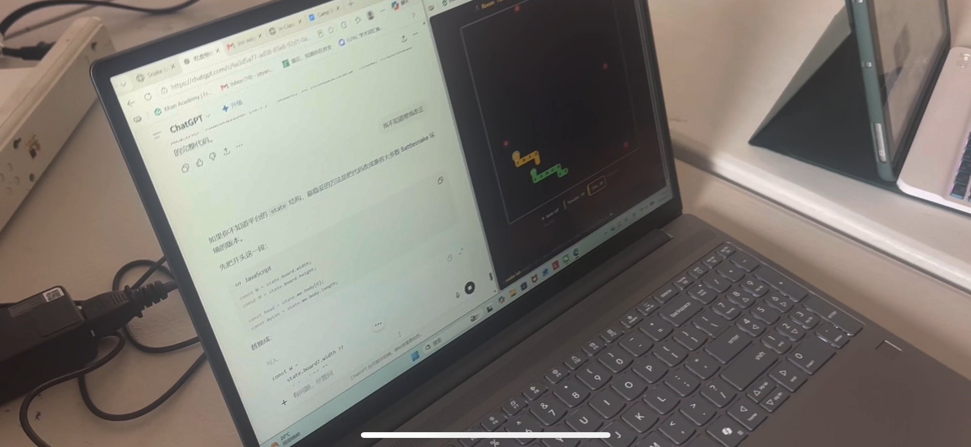 A Snake-Lab camp student's laptop: a ChatGPT conversation about snake-bot code on one half of the screen, the live Snake arena running on the other