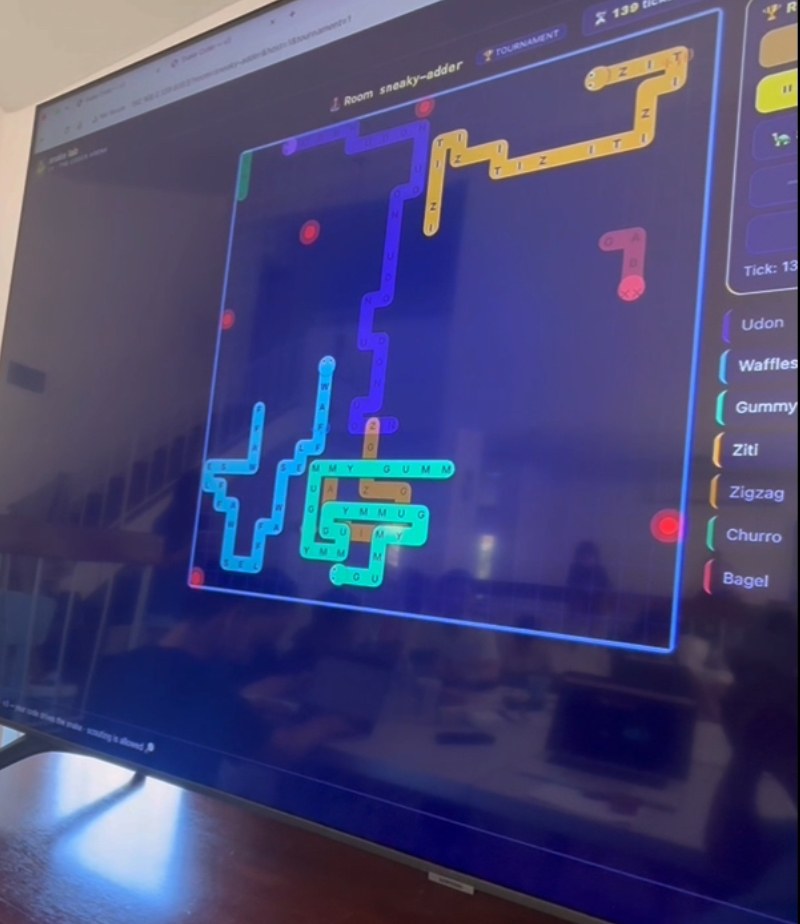 Snake-Lab multi-snake arena on a classroom display