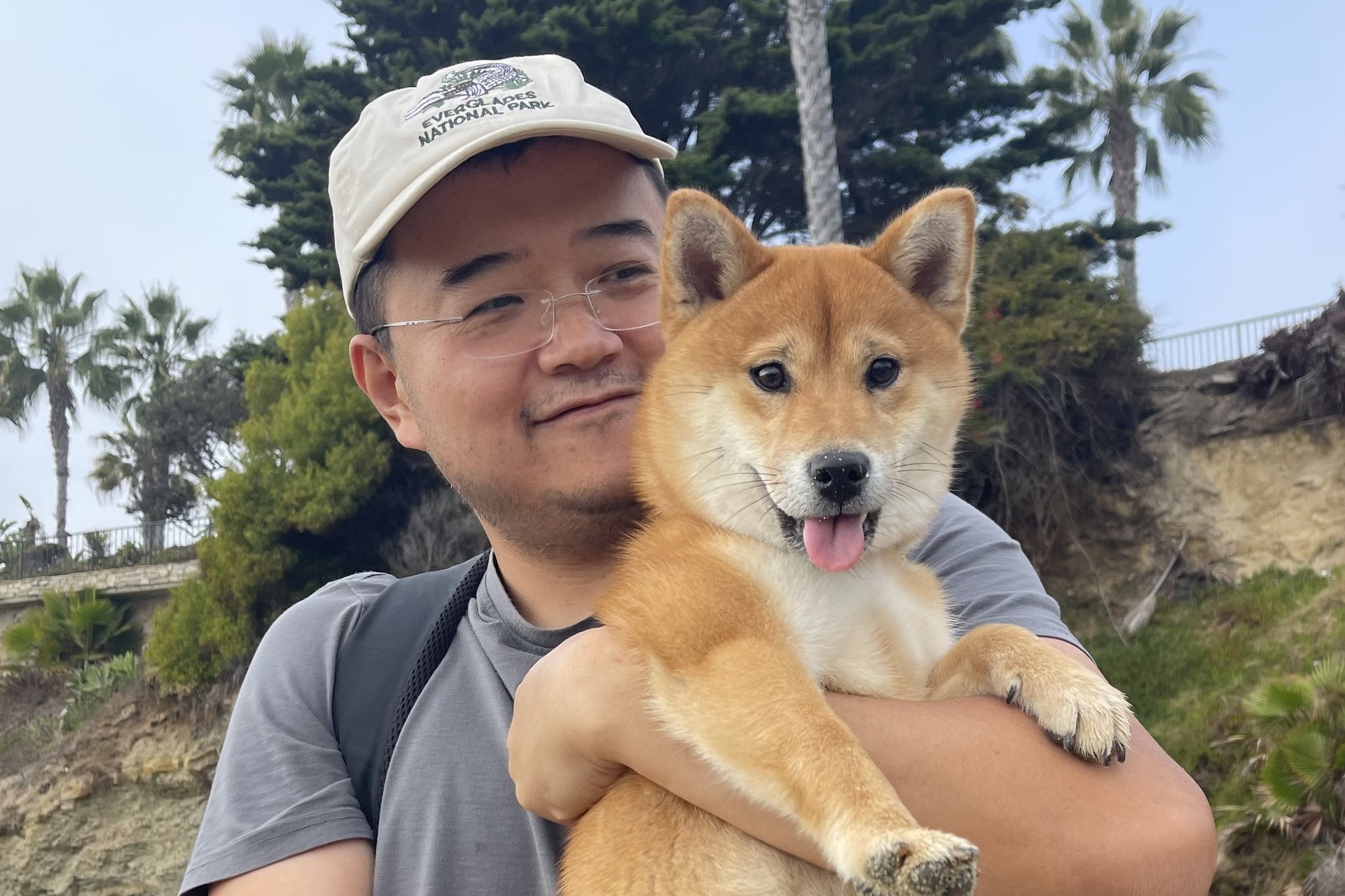 Yancy Qin, founder of Lucas Academy, holding his Shiba Inu
